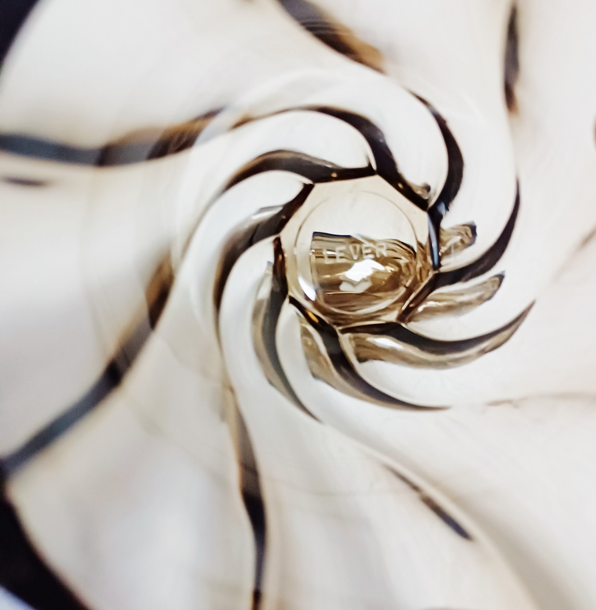 Gros plan sur le motif tourbillon du vase en verre fumé Lever.